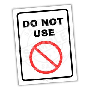 May include: A rectangular sign with a white background and a black border. The words "DO NOT USE" are printed in bold black letters. A red circle with a diagonal line through it is centered below the text.