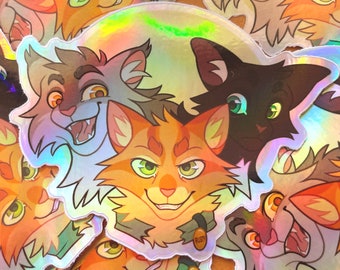 May include: Holographic stickers featuring cartoon cat illustrations. The stickers showcase various cat faces in shades of orange, brown, and black, with detailed facial expressions. One sticker has the name "RUSTY" on a tag.