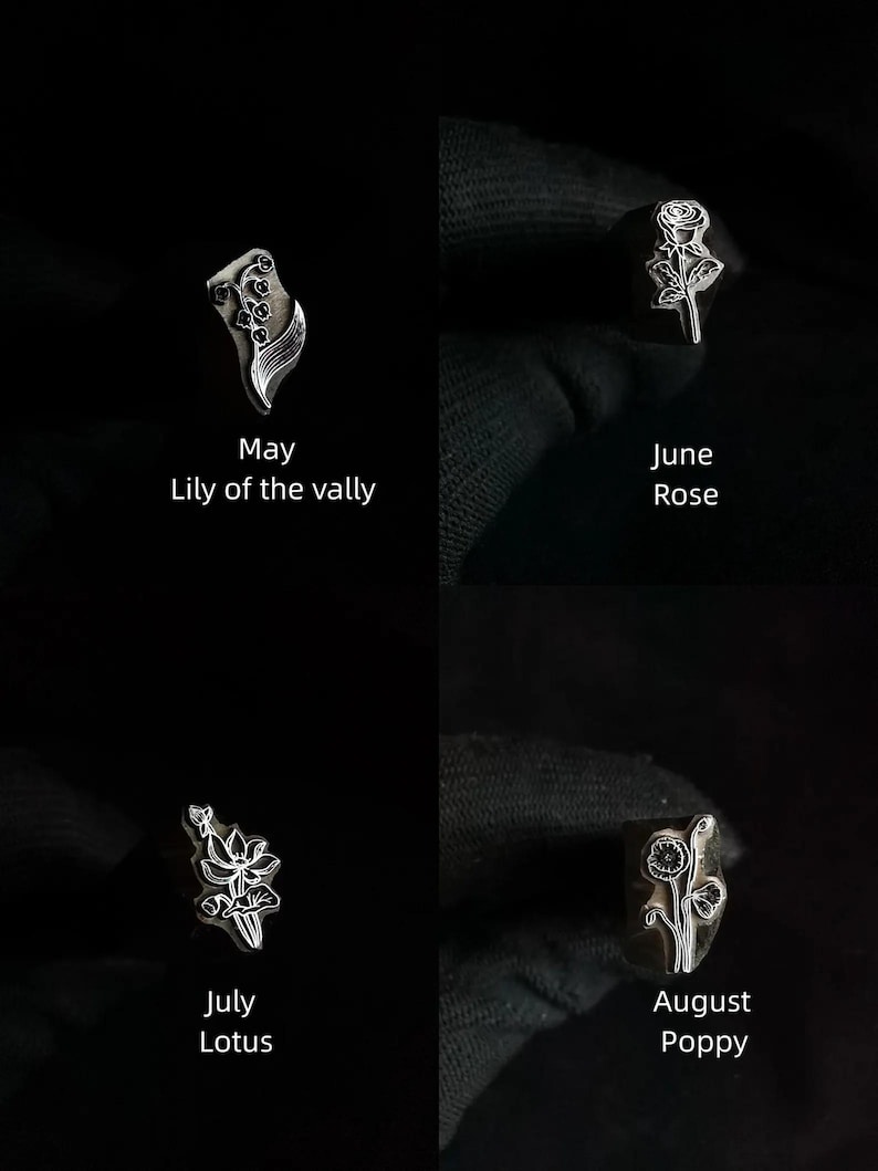 Pu&ograve; includere: Quattro timbri metallici con disegni floreali che rappresentano i mesi di maggio, giugno, luglio e agosto. I timbri sono disposti in una griglia su uno sfondo nero. I fiori sono mughetto, rosa, loto e papavero.