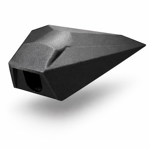 May include: A black, geometric object with a textured surface. The object has a faceted design and a rectangular opening on one end. It appears to be a modern, abstract sculpture or decorative piece, possibly a pencil holder or a similar desk accessory.