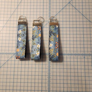 Beautiful key chain made with Rifle Paper Co fabric. Measures 5.5 inches.