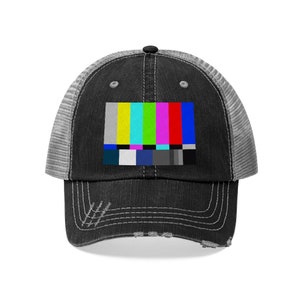 May include: A black and gray distressed trucker hat with a colorful TV test pattern graphic on the front.