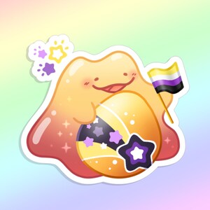 May include: A sticker of a cartoon character with a smiling face, holding a non-binary pride flag. The character is orange, yellow, and pink, with a shooting star design and purple stars. The background is a soft gradient of pastel colours.