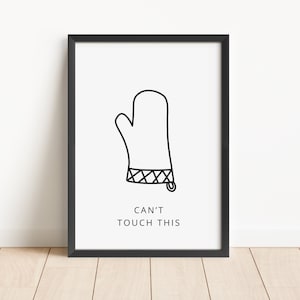 May include: Black and white illustration of an oven mitt with the text "Can't Touch This" printed below it. The image is framed in a black frame.