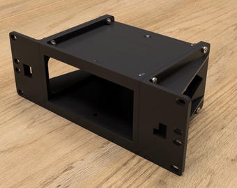 May include: Black metal bracket with a rectangular opening and several screws. The bracket is angled and has a flat surface on top.