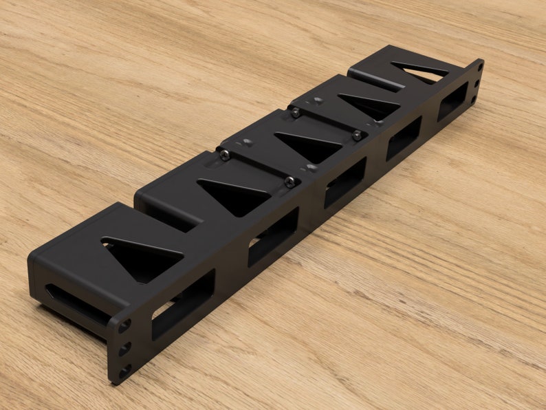 May include: Black metal magazine rack with six slots for holding magazines or other items. The rack is mounted on a wall.