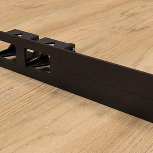 May include: Black metal rack with three rectangular cutouts. The rack is designed to hold equipment in a server rack.