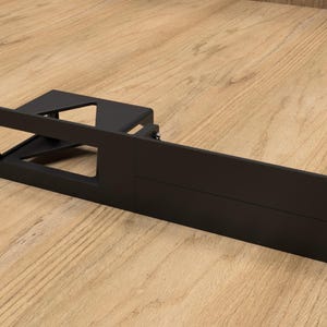 May include: Black metal rack with a rectangular opening and multiple mounting holes. The rack is designed for mounting equipment in a server rack.