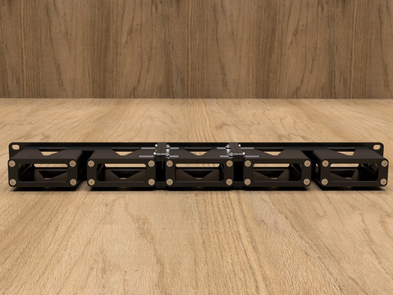 May include: A black metal rack with five compartments for holding items. The rack is mounted on a wooden surface.