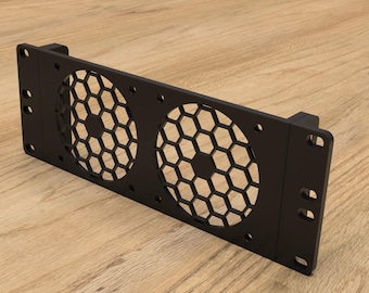 May include: Black metal fan grill with two hexagonal mesh openings. The grill has mounting brackets on both sides.