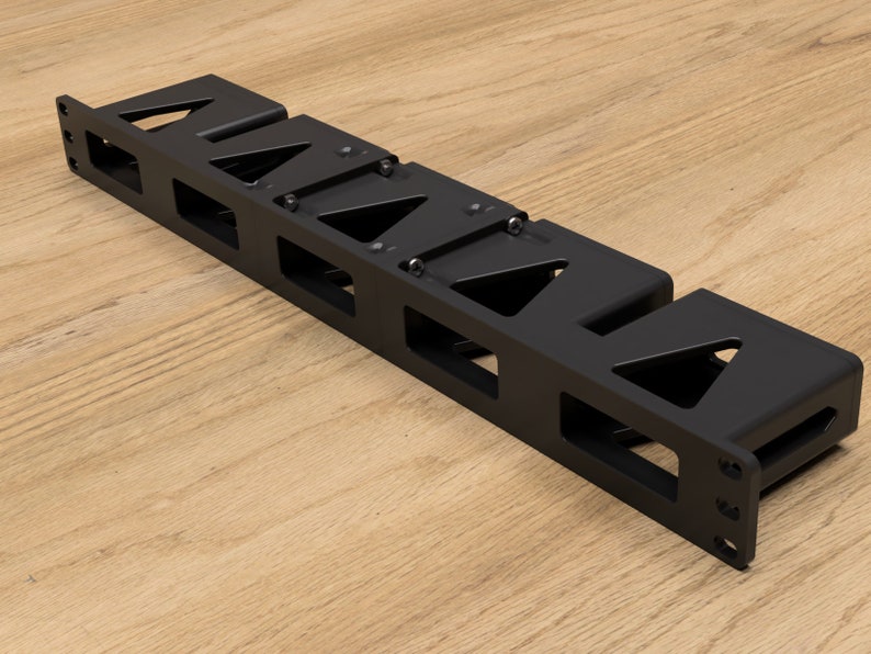 May include: Black metal rack with five slots for holding items. The rack has a rectangular shape and is designed to be mounted on a wall.