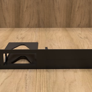 May include: Black metal rack with mounting holes and a cutout for a device. The rack is designed for mounting in a server rack.