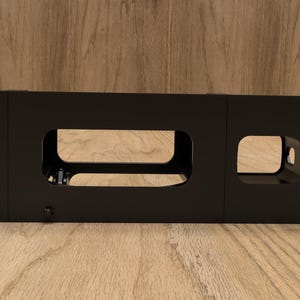 May include: Black metal rack with two rectangular openings. The rack is designed to hold equipment in a server rack.
