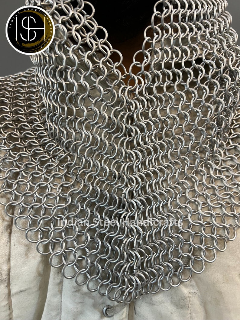 May include: A silver chainmail collar, made of interlocking metal rings. The collar is a traditional piece of armour, often worn for historical reenactment or cosplay.