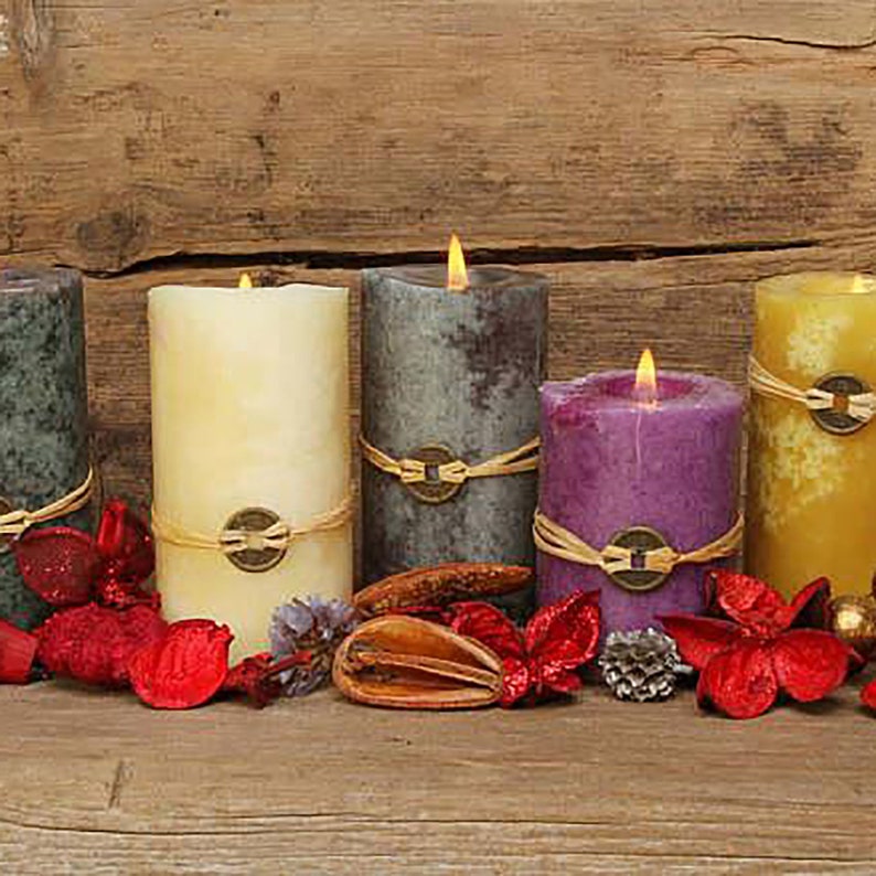 May include: Five candles of different colors and designs, including cream, purple, gray, and yellow, are arranged on a wooden surface. The candles are decorated with twine and have a rustic, natural look.