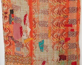May include: An orange and beige textile with a patchwork design. The textile features a variety of patterns, including zigzags, stripes, and geometric shapes. Patches of various colors, including red, pink, and blue, are sewn onto the fabric. The textile is likely a quilt or blanket.