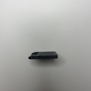 May include: A black floppy disk with a label on the front.