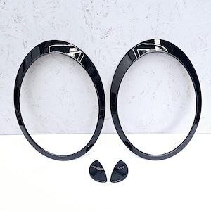 May include: Two black plastic headlight rings with two black plastic clips.