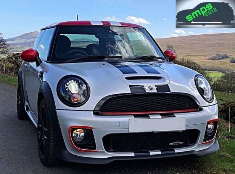 May include: A silver Mini Cooper with black and red racing stripes. The car has black wheels and a black grille with a Mini logo.