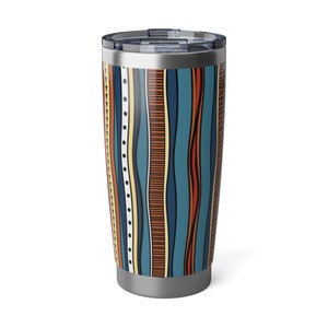 May include: A stainless steel travel tumbler with a colorful, vertical pattern. The design features wavy stripes in shades of blue, orange, and cream. The tumbler has a silver lid and base, and is designed to keep beverages hot or cold.