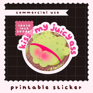 May include: A printable sticker featuring a light green frog with pink cheeks wearing a bright pink thong, positioned on a brown circular base. The text "kiss my juicy ass" is written in pink letters around the frog. Includes "10x10 inch 300dpi" text.