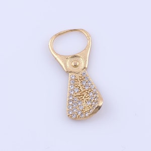 May include: Gold-toned charm with a ring at the top and a teardrop-shaped design covered in clear rhinestones.