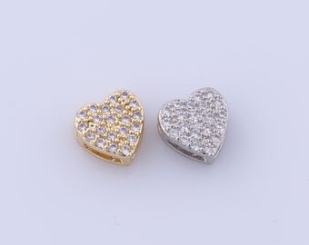 May include: Two heart-shaped charms, one gold and one silver, both covered in small clear rhinestones.