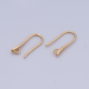 May include: Two gold-toned earring hooks. The hooks are made of metal and have a smooth, rounded finish.