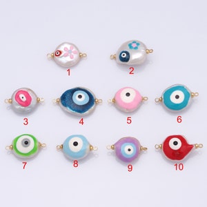 May include: Ten different styles of white pearl beads with evil eye charms. Each bead has a different color and design, including pink, blue, green, purple, and red. The beads have gold jump rings on either side.