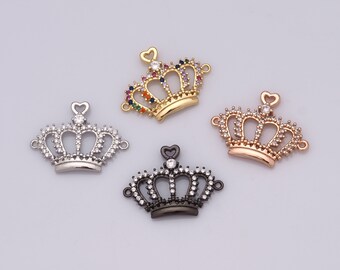 May include: Four crown charms with clear and colorful rhinestones. The charms are in silver, gold, rose gold, and black.