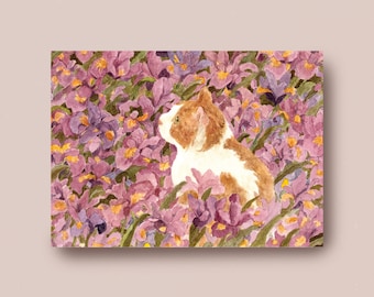 Ginger cat in violet iris garden
