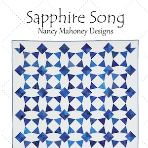 May include: A quilt pattern called "Sapphire Song" by Nancy Mahoney Designs. The quilt is made up of blue and white triangles and is 68 1/2 inches by 80 1/2 inches.