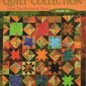 May include: A book cover for "Creative Quilt Collection" Volume Two. The cover features a colorful patchwork quilt design with star and square patterns in shades of orange, green, blue, and brown. The title is in white and the publisher's logo is in the upper right corner.