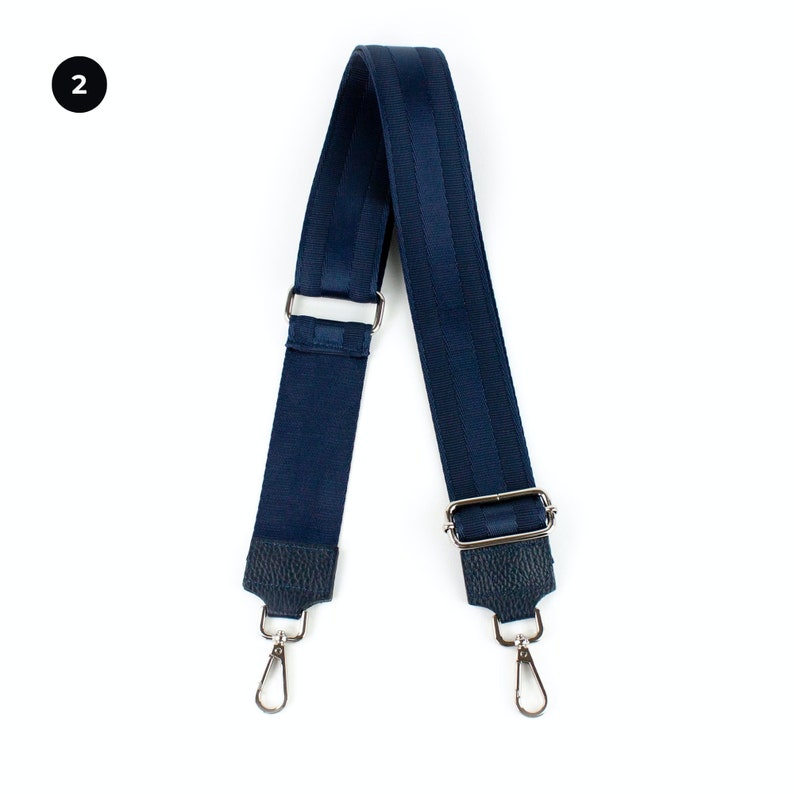 a pair of blue suspenders with two metal hooks