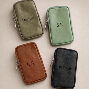 May include: Four rectangular zippered pouches in olive green, sage green, brown, and black. Each pouch features a textured surface and a silver-tone zip. The olive pouch says i love you, the sage says S.P., the brown says L.S., and the black says My Sweety.