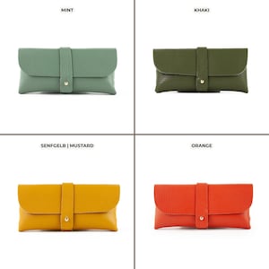 four different colors of clutches and purses