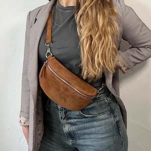 Marsupio da donna in pelle scamosciata color cognac, con tracolla intercambiabile.