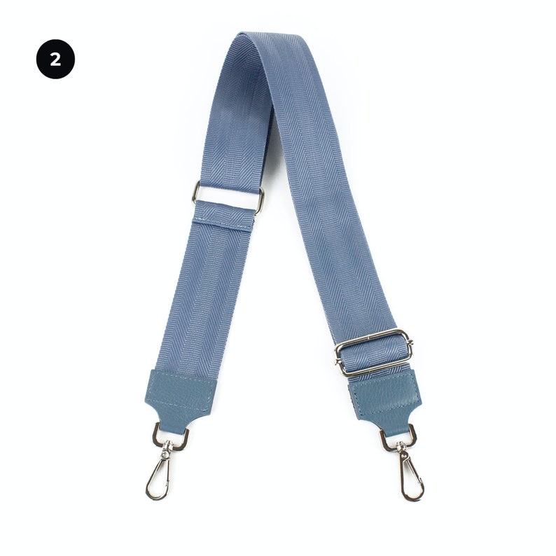 a pair of blue suspenders with metal buckles