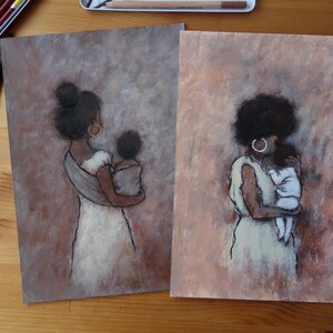 May include: Two pastel art prints depicting a mother and child. The figures are seen from behind, with the mothers in white dresses, cradling their children. The backgrounds are soft brown and pink.