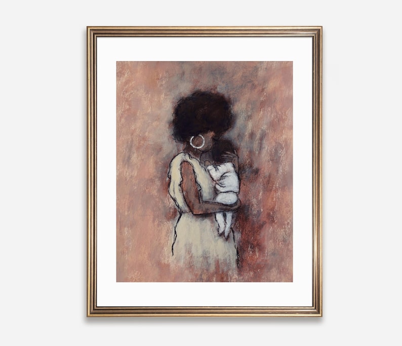 May include: A framed art print depicting a mother and child. The illustration uses a sketch-like style with a warm palette of pinks and browns. The mother wears a cream dress and hoop earrings. The baby is wrapped in white.