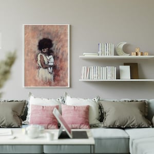 May include: A framed art print depicting a woman cradling a baby, in peach, brown, and white hues. The artwork hangs above a grey sofa with pink and grey cushions. The room is decorated with shelves, books, and a decorative crescent moon.