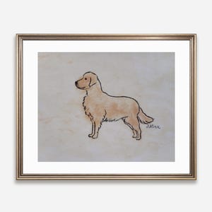 May include: A framed artwork featuring a Golden Retriever dog illustration. The dog is depicted in profile with a light brown coat and black outline. The artwork is signed in the bottom right corner and framed in a gold-colored frame.