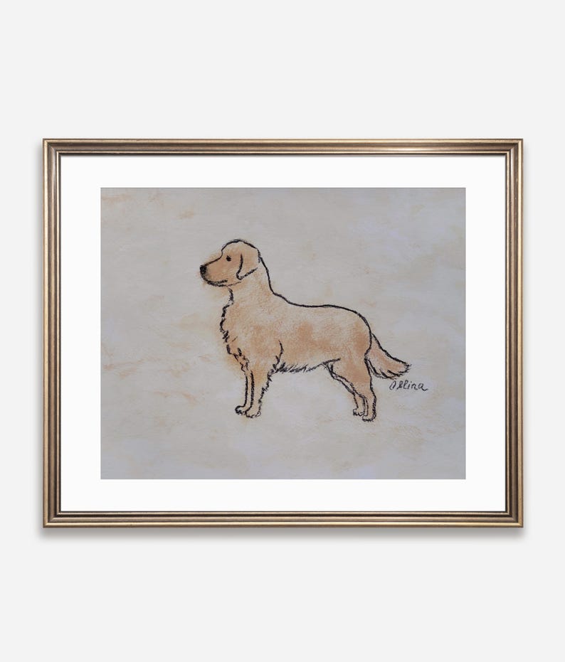 May include: A framed artwork featuring a Golden Retriever dog illustration. The dog is depicted in profile with a light brown coat and black outline. The artwork is signed in the bottom right corner and framed in a gold-colored frame.