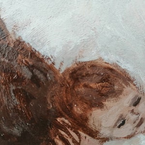 May include: A close-up of a painting depicting a person's face. The face is painted in shades of brown and white, with the eyes closed. The background is a light blue color.
