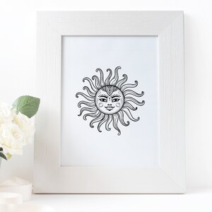 May include: A black and white line drawing of a sun with a face inside. The sun is framed in a white frame.
