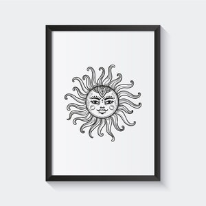 May include: Black and white line art print of a sun with a face in a black frame.