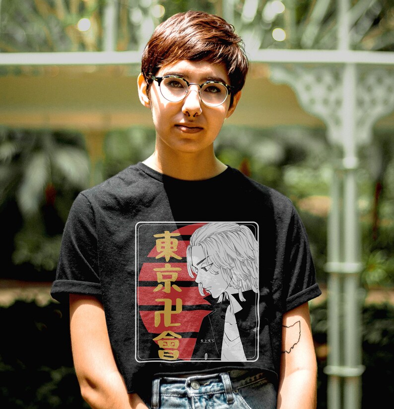 May include: A black t-shirt with a graphic print of a character from a Japanese anime. The graphic features a red and white sun with the text "東京卍會" in gold lettering.