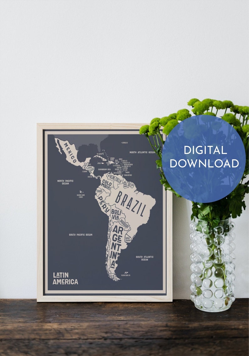 May include: A framed map of Latin America with the countries outlined in beige and the names of the countries in white text on a dark blue background. The map is surrounded by a light wood frame. The text "DIGITAL DOWNLOAD" is in a blue circle on the right side of the image.