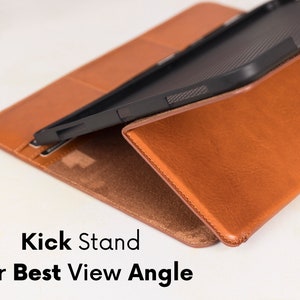 May include: A tan tablet case with a smooth exterior and a black interior frame, featuring a built-in kickstand for adjustable viewing angles. The text Kick Stand for Best View Angle is printed in black on the lower portion of the image.