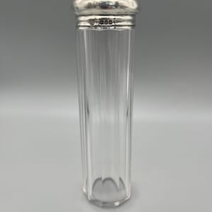 May include: A clear glass jar with a silver lid. The lid has a small inscription that reads "T.M. & Co."